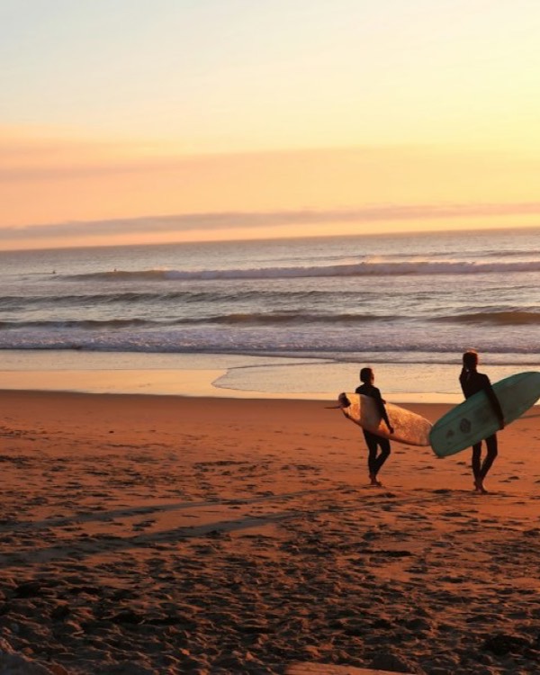 Surfista al atardecer en la playa